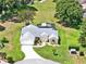 Aerial shot of home showcasing a well-maintained lawn, lush landscaping, and a screened-in pool at 25400 Waterbrook Ct, Leesburg, FL 34748