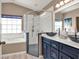 Bright bathroom with large tub, glass shower, and modern vanity with vessel sinks at 25400 Waterbrook Ct, Leesburg, FL 34748