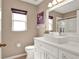 Modern bathroom featuring white vanity, chrome faucet, stylish sink, and framed mirror at 25400 Waterbrook Ct, Leesburg, FL 34748