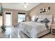 Bright bedroom features stylish decor, light wood floors, ceiling fan, and access to the outside at 25400 Waterbrook Ct, Leesburg, FL 34748