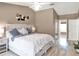 Bright and airy bedroom boasts neutral walls, light wood floors, and stylish decor at 25400 Waterbrook Ct, Leesburg, FL 34748