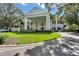 Stately clubhouse with a circular drive, covered entrance, and lush landscaping at 25400 Waterbrook Ct, Leesburg, FL 34748