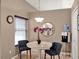 Cozy dining area featuring a round table with a marble top, elegant chairs, and neutral wall color at 25400 Waterbrook Ct, Leesburg, FL 34748