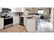 Well-lit kitchen with modern stainless steel appliances and a breakfast bar at 25400 Waterbrook Ct, Leesburg, FL 34748
