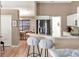 Spacious kitchen featuring barstool seating, stainless steel appliances, and neutral wall colors at 25400 Waterbrook Ct, Leesburg, FL 34748