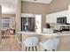 Spacious kitchen featuring barstool seating, stainless steel appliances, and neutral wall colors at 25400 Waterbrook Ct, Leesburg, FL 34748