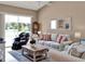 Open living room filled with natural light and featuring a comfortable seating arrangement at 25400 Waterbrook Ct, Leesburg, FL 34748