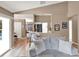 Open living room showcasing barstool seating, a comfortable sofa, and neutral wall color at 25400 Waterbrook Ct, Leesburg, FL 34748