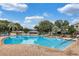 Enjoy the community pool with brick pavers, blue skies, and plenty of seating at 25400 Waterbrook Ct, Leesburg, FL 34748