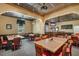 Inviting dining area featuring wood tables and a classic bar setup at 25400 Waterbrook Ct, Leesburg, FL 34748