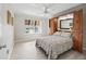 Comfortable bedroom with built-in storage and a garden view from the window at 2620 Persimmon Loop, The Villages, FL 32162