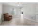 Bright and airy bedroom with light wood floors, a ceiling fan, and a comfortable armchair at 2620 Persimmon Loop, The Villages, FL 32162