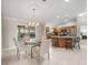 Bright dining area adjacent to the kitchen, featuring a modern chandelier and tile flooring at 2620 Persimmon Loop, The Villages, FL 32162