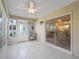 Sunlit Florida room with tile floors, slider to dining, an exterior door and an adjacent wall at 2620 Persimmon Loop, The Villages, FL 32162