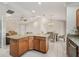 Open kitchen with island, granite countertops, and a dining area, perfect for entertaining and Gathering meals at 2620 Persimmon Loop, The Villages, FL 32162