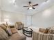 Comfortable living room with neutral tones and stylish furnishings, illuminated by a ceiling fan and recessed lighting at 2620 Persimmon Loop, The Villages, FL 32162