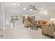 Spacious living room with an open floor plan connecting to the kitchen and dining area, perfect for entertaining at 2620 Persimmon Loop, The Villages, FL 32162
