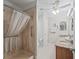 Main bathroom with a shower and a vanity with granite countertop and double sinks at 2620 Persimmon Loop, The Villages, FL 32162