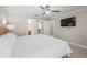 Spacious main bedroom features en-suite bathroom and walk-in closet access, with a mounted TV at 2620 Persimmon Loop, The Villages, FL 32162