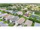 An aerial view showcases the community with well-maintained lawns, mature trees, and varied rooflines at 2746 Edwards Ln, The Villages, FL 32162