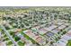 Expansive aerial shot featuring a dense neighborhood with green spaces and a golf course in the distance at 2746 Edwards Ln, The Villages, FL 32162