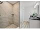 Luxurious bathroom featuring a glass-enclosed shower with marble-look tile and a vanity at 2746 Edwards Ln, The Villages, FL 32162