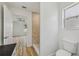Modern bathroom featuring tile floors, a marble glass shower, and an open doorway to the bedroom at 2746 Edwards Ln, The Villages, FL 32162