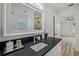Stylish bathroom with a sleek vanity, a large mirror and access to a shower at 2746 Edwards Ln, The Villages, FL 32162