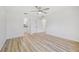 Bright bedroom featuring wood-look flooring, closet space and ensuite bathroom access at 2746 Edwards Ln, The Villages, FL 32162