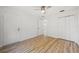 Bright bedroom features wood-look floors, closet space, and a doorway at 2746 Edwards Ln, The Villages, FL 32162