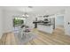 Dining area with modern finishes, connecting the kitchen with a view of the outdoors at 2746 Edwards Ln, The Villages, FL 32162