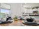 Close up on a stylish dining table, set elegantly with dinnerware, connecting to the modern kitchen at 2746 Edwards Ln, The Villages, FL 32162