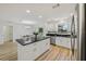 Open-concept kitchen featuring a large island, stainless steel appliances, and ample natural light at 2746 Edwards Ln, The Villages, FL 32162