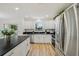 Modern kitchen with white cabinets, stainless steel appliances, and a view of the backyard at 2746 Edwards Ln, The Villages, FL 32162