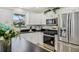 Updated kitchen showcasing white cabinetry, stainless steel appliances, and stylish decor at 2746 Edwards Ln, The Villages, FL 32162