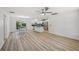 An open-concept design with modern floors connecting living, dining, and kitchen areas at 2746 Edwards Ln, The Villages, FL 32162