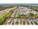 Community aerial view showcasing modern homes, parking, and amenities near roadways and the waterfront at 2755 Bobcat Chase Blvd, Oakland, FL 34787