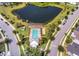 Drone view showcasing a community pool, cabana, and pond, all interconnected by sidewalks at 2755 Bobcat Chase Blvd, Oakland, FL 34787