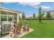 Landscaped backyard features a brick patio with outdoor seating and a screened-in porch, great for entertaining at 2755 Bobcat Chase Blvd, Oakland, FL 34787