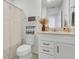 Well-lit bathroom featuring a vanity, toilet, and shower with a patterned curtain at 2755 Bobcat Chase Blvd, Oakland, FL 34787