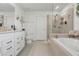 Elegant bathroom with a sleek vanity, bathtub and a glass-enclosed shower at 2755 Bobcat Chase Blvd, Oakland, FL 34787