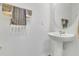 Simple bathroom with a vessel sink, round mirror, and wall-mounted towel bars at 2755 Bobcat Chase Blvd, Oakland, FL 34787