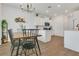 Open-concept dining area connected to kitchen, featuring hardwood floors at 2755 Bobcat Chase Blvd, Oakland, FL 34787