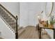 Welcoming entryway with wood floors, a staircase, and decorative table at 2755 Bobcat Chase Blvd, Oakland, FL 34787