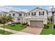 Beautiful two-story home with a brick driveway and a two-car garage, offering a blend of style and convenience at 2755 Bobcat Chase Blvd, Oakland, FL 34787