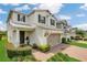 Charming two-story home features a well-manicured front lawn and a two-car garage with pergola at 2755 Bobcat Chase Blvd, Oakland, FL 34787
