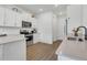 Modern kitchen with stainless steel appliances, white cabinets, and quartz countertops at 2755 Bobcat Chase Blvd, Oakland, FL 34787