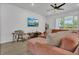 Cozy living room with an inviting sofa, large window, and stylish decor at 2755 Bobcat Chase Blvd, Oakland, FL 34787