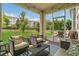 Relaxing screened-in patio with comfortable seating and a view of the backyard at 2755 Bobcat Chase Blvd, Oakland, FL 34787