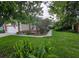 Well-manicured front yard showcasing vibrant landscaping and mature trees at 2842 Ithaca Ct, Orlando, FL 32826